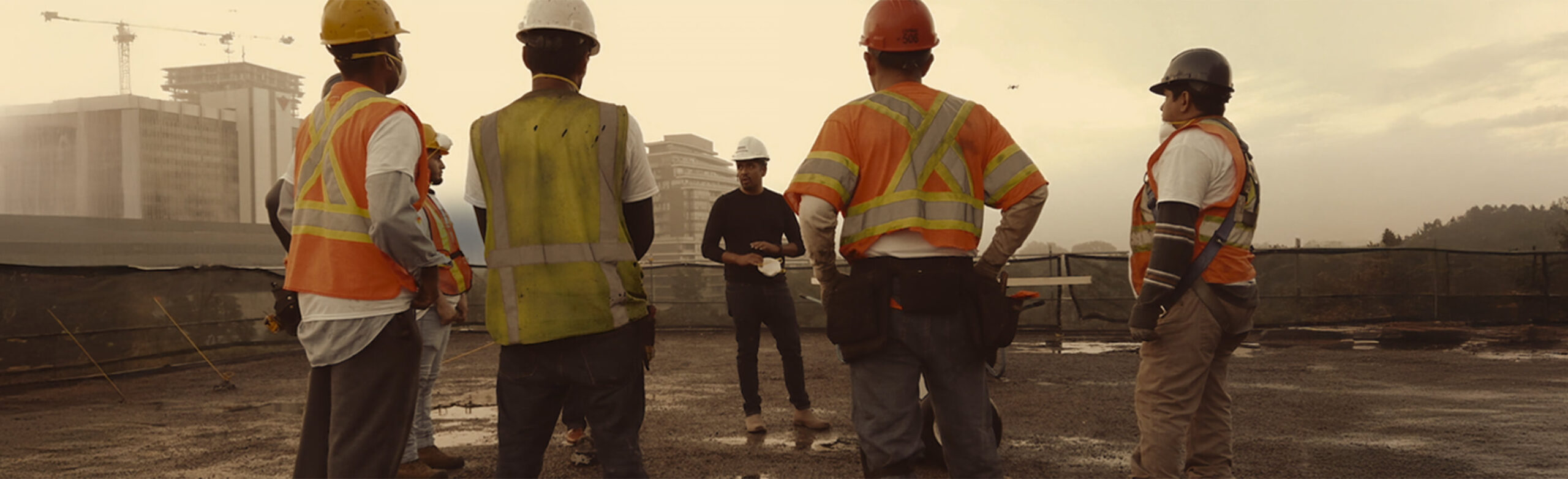 A crew meeting on a large building deck